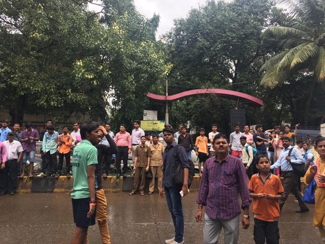 People wait for news near the site. (HT) People wait for news near the site. (HT)