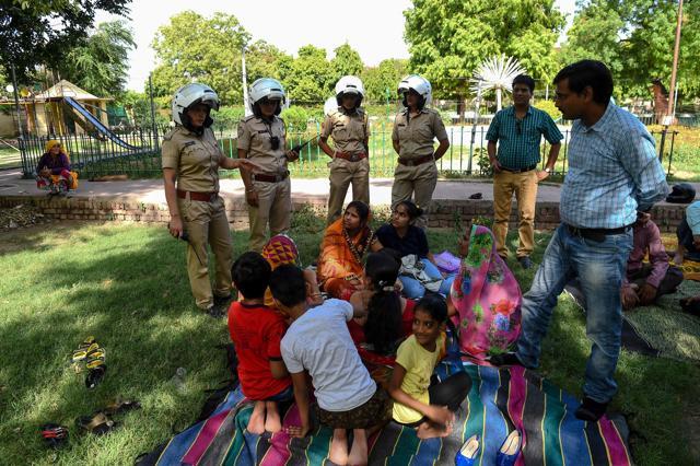 Members of the female patrol unit explain to women and children about the women's helpline numbers, in a park in Jaipur. (AFP Photo) Members of the female patrol unit explain to women and children about the women's helpline numbers, in a park in Jaipur. (AFP Photo)