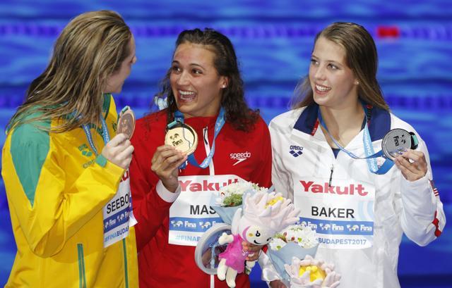Canada's gold medal winner Kylie Jacqueline Masse, center, United States' silver medal winner Kathleen Baker, right, and Australia's bronze medal winner Emily Seebohm, left, pose with their medals after the women's 100m backstroke final during the World swimming championships in Budapest on Tuesday. (AP)