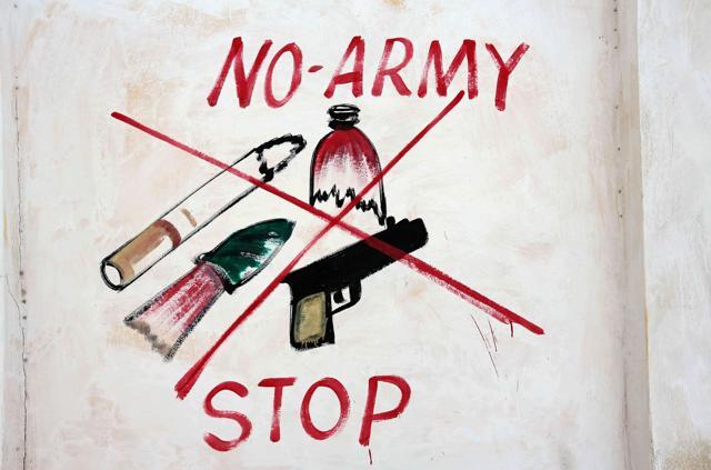 An illustration prohibiting weapons, broken bottles, cigarettes and military is seen on a wall of a stadium in Mogadishu’s Hodan district. (Feisal Omar / REUTERS) An illustration prohibiting weapons, broken bottles, cigarettes and military is seen on a wall of a stadium in Mogadishu’s Hodan district. (Feisal Omar / REUTERS)