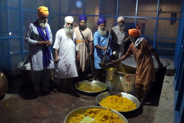A volunteer pouring langar in a bucket meant for distribution among the devotees in the kitchen of Takht Damdama Sahib in Talwandi Sabo. (Sanjeev Kumar/HT Photo) A volunteer pouring langar in a bucket meant for distribution among the devotees in the kitchen of Takht Damdama Sahib in Talwandi Sabo. (Sanjeev Kumar/HT Photo)