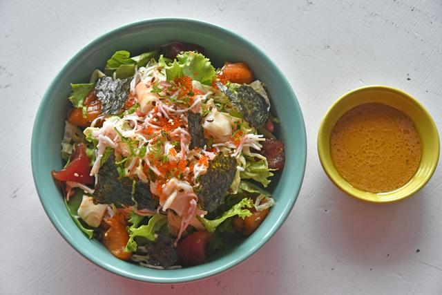 The chirashi seafood salad with its lashings of shredded kani (imitation crab stick), chunky tuna pieces and refreshing tartness was a rare win at Hello Guppy. (Shashi Kashyap / HT Photo)
