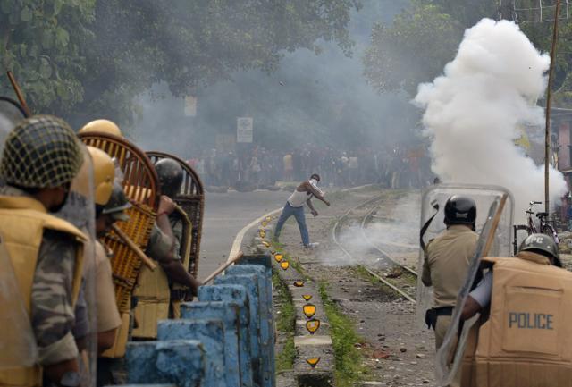 A supporter of separate Gorkhaland state throws a projectile at police during an indefinite strike at Sukna village on the outskirts of Siliguri on Saturday. (AFP) A supporter of separate Gorkhaland state throws a projectile at police during an indefinite strike at Sukna village on the outskirts of Siliguri on Saturday. (AFP)