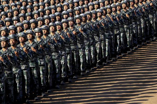 In this photo released by China's Xinhua News Agency, Chinese People's Liberation Army (PLA) troops march in formation as they arrive for the military parade. (AP) In this photo released by China's Xinhua News Agency, Chinese People's Liberation Army (PLA) troops march in formation as they arrive for the military parade. (AP)