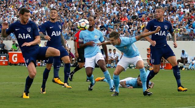John Stones of Manchester City lowers his head to deflect the ball into the net for a goal. (AFP)