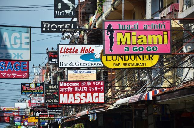 Massage and other multicolored signs on the street of Beach Road, Pattaya. The average price for one hour of oil massage is 300 baht, around 10 dollars. (Shutterstock)