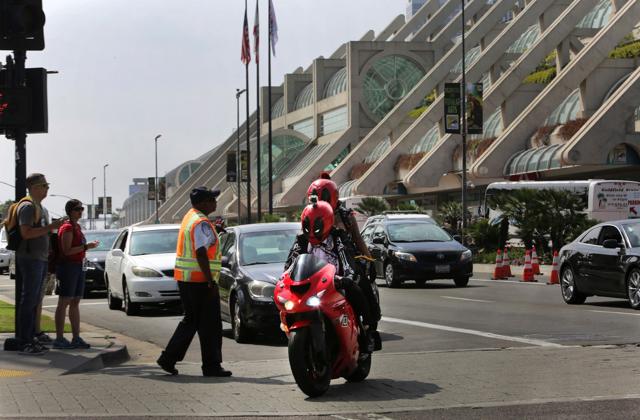 Characters inspired by Deadpool comic book characters ride past the San Diego Convention Center where Comic-2017 is being held in San Diego, California on July 20. (AFP)