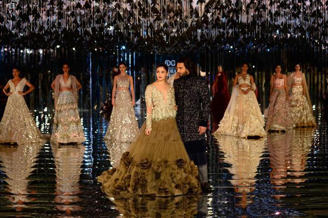 Alia Bhat and Ranveer Singh present creations by fashion designer Manish Malhotra during the FDCI India Couture week 2017. (AFP)