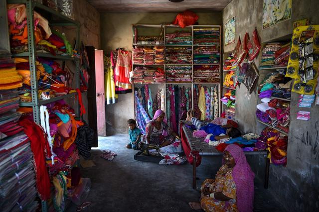 Dhanki (centre) has been living in India for 16 years, at an artisan shop in an unauthorised settlement for Pakistani Hindus in Jodhpur. (AFP Photo) Dhanki (centre) has been living in India for 16 years, at an artisan shop in an unauthorised settlement for Pakistani Hindus in Jodhpur. (AFP Photo)