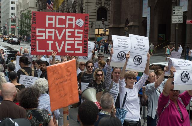 Protesters carry signs during a health care rally in front of Trump Tower on July 29, 2017 in New York. (AFP) Protesters carry signs during a health care rally in front of Trump Tower on July 29, 2017 in New York. (AFP)