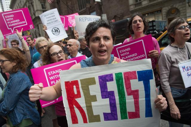 Protesters carry signs during a health care rally in front of Trump Tower on July 29, 2017 in New York. (AFP) Protesters carry signs during a health care rally in front of Trump Tower on July 29, 2017 in New York. (AFP)