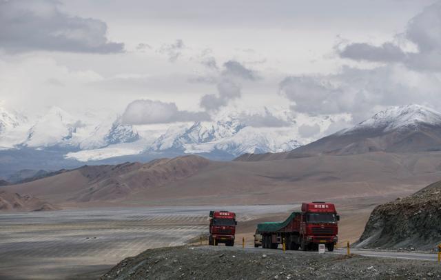 Trucks driving along the China-Pakistan Friendship Highway before the Karakorum mountain range near Tashkurgan in China's western Xinjiang province. (AFP)