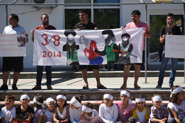 Iraqi Yazidi refugees attend a commemoration of the third anniversary of the Yazidi genocide in Sinjar region, in the village of Nea Apollonia where more than 400 Yazidis live in apartments provided by a UNHCR-sponsored housing scheme, near Thessaloniki, Greece, August 3, 2017. (Reuters Photo) Iraqi Yazidi refugees attend a commemoration of the third anniversary of the Yazidi genocide in Sinjar region, in the village of Nea Apollonia where more than 400 Yazidis live in apartments provided by a UNHCR-sponsored housing scheme, near Thessaloniki, Greece, August 3, 2017. (Reuters Photo)