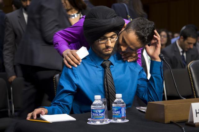 Harpreet Singh Saini gets a hug from his brother Kamal before testifying before the US Senate on September 19, 2012. (AP File) Harpreet Singh Saini gets a hug from his brother Kamal before testifying before the US Senate on September 19, 2012. (AP File)