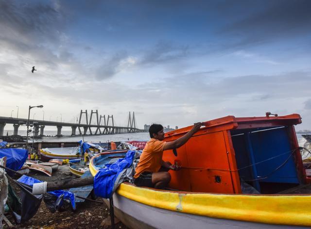 As part of their preparations for the festival, fishermen repair and paint their boats and nets. (Kunal Patil/HT) As part of their preparations for the festival, fishermen repair and paint their boats and nets. (Kunal Patil/HT)