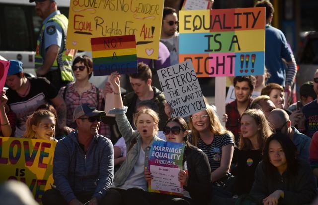 Supporters of same sex marriage carry banners and shout slogans as they gather on a street in Sydney on August 6, 2017. (AFP) Supporters of same sex marriage carry banners and shout slogans as they gather on a street in Sydney on August 6, 2017. (AFP)