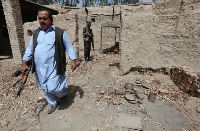 A policeman in plain clothes (L) walks out of a damaged house, which witnesses said belonged to Hafeez Brohi, wanted in connection with bombings in Shikarpur and suspected in many other blasts in Sindh province, on the outskirts of Shikarpur. (REUTERS) A policeman in plain clothes (L) walks out of a damaged house, which witnesses said belonged to Hafeez Brohi, wanted in connection with bombings in Shikarpur and suspected in many other blasts in Sindh province, on the outskirts of Shikarpur. (REUTERS)