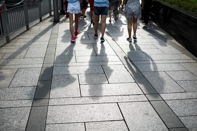In this photograph taken on August 1, 2017, Chinese women walk in the Lujiazui financial district in Pudong in Shanghai. (AFP)