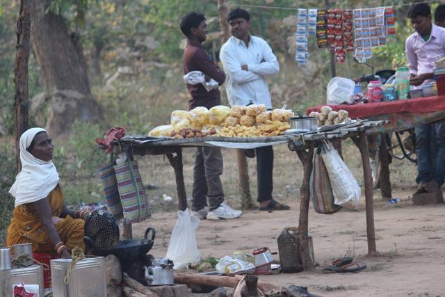 A woman vendor awaits customers for sweetmeats and savories at the weekly haat in Bhainsasur village, 15 km inside the forests near Antahgarh block in south Bastar. (Ritesh Mishra / HT Photo) A woman vendor awaits customers for sweetmeats and savories at the weekly haat in Bhainsasur village, 15 km inside the forests near Antahgarh block in south Bastar. (Ritesh Mishra / HT Photo)