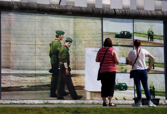 Visitors look at the art installation Beyond The Wall. (Reuters Photo) Visitors look at the art installation Beyond The Wall. (Reuters Photo)