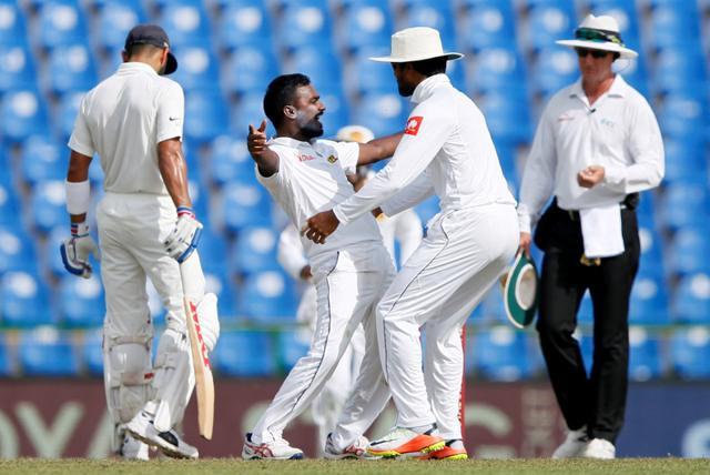 Sri Lanka's Malinda Pushpakumara celebrates with captain Dinesh Chandimal after taking the wicket of India's Ajinkya Rahane. (REUTERS) Sri Lanka's Malinda Pushpakumara celebrates with captain Dinesh Chandimal after taking the wicket of India's Ajinkya Rahane. (REUTERS)