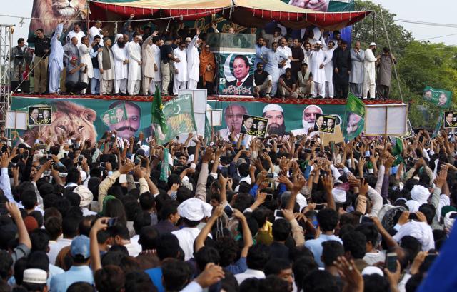 Supporters of deposed Pakistani Prime Minister Nawaz Sharif greet their leader as he arrives to address a rally in Gujrat, Pakistan, on Friday. (AP) Supporters of deposed Pakistani Prime Minister Nawaz Sharif greet their leader as he arrives to address a rally in Gujrat, Pakistan, on Friday. (AP)
