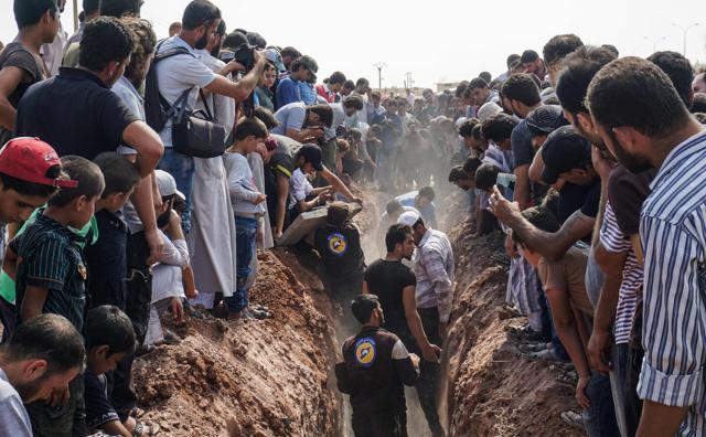 Members of the Syrian civil defence volunteers, also known as the White Helmets, bury their fellow comrades during a funeral in Sarmin, a jihadist-held town 9 km east of Idlib on August 12, 2017. (AFP) Members of the Syrian civil defence volunteers, also known as the White Helmets, bury their fellow comrades during a funeral in Sarmin, a jihadist-held town 9 km east of Idlib on August 12, 2017. (AFP)