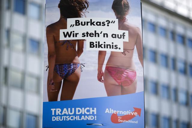 An election campaign poster of the German anti-immigrant party AfD reading "Burkas? We like bikinis." is displayed in central Berlin, Germany. (AP Photo)
