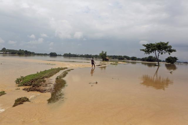 Shrawan Ram, 17, walks through a flooded area to reach his inundated home in Saptari district, Nepal, on August 14, 2017. (AP) Shrawan Ram, 17, walks through a flooded area to reach his inundated home in Saptari district, Nepal, on August 14, 2017. (AP)
