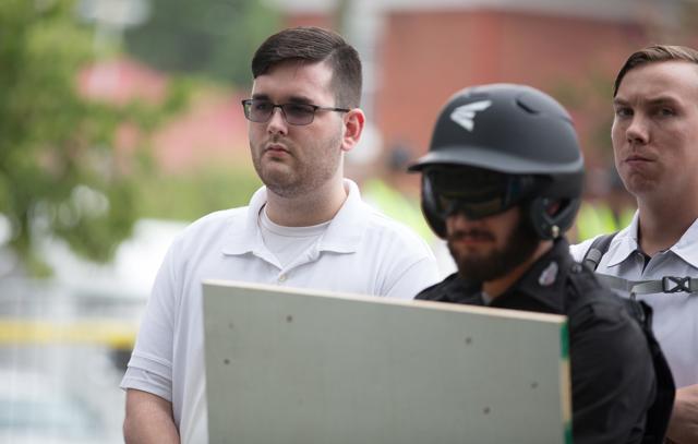James Alex Fields (left) is seen attending the "Unite the Right" rally in Emancipation Park before being arrested by police and charged with charged with one count of second degree murder, three counts of malicious wounding and one count of failing to stop at an accident that resulted in a death after police say he drove a car into a crowd of protesters in Charlottesville, Virginia, on August 12, 2017. (Reuters) James Alex Fields (left) is seen attending the "Unite the Right" rally in Emancipation Park before being arrested by police and charged with charged with one count of second degree murder, three counts of malicious wounding and one count of failing to stop at an accident that resulted in a death after police say he drove a car into a crowd of protesters in Charlottesville, Virginia, on August 12, 2017. (Reuters)