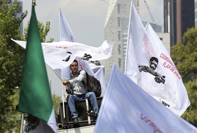 A man on the top of a van waves a flag during a farmers' protest in Mexico City, Monday, Aug. 7, 2017. Farmers marched to the Interior Ministry demanding the agricultural sector be removed from the North American Free Trade Agreement as the Trump administration prepares to renegotiate NAFTA with Mexico and Canada. (AP) A man on the top of a van waves a flag during a farmers' protest in Mexico City, Monday, Aug. 7, 2017. Farmers marched to the Interior Ministry demanding the agricultural sector be removed from the North American Free Trade Agreement as the Trump administration prepares to renegotiate NAFTA with Mexico and Canada. (AP)