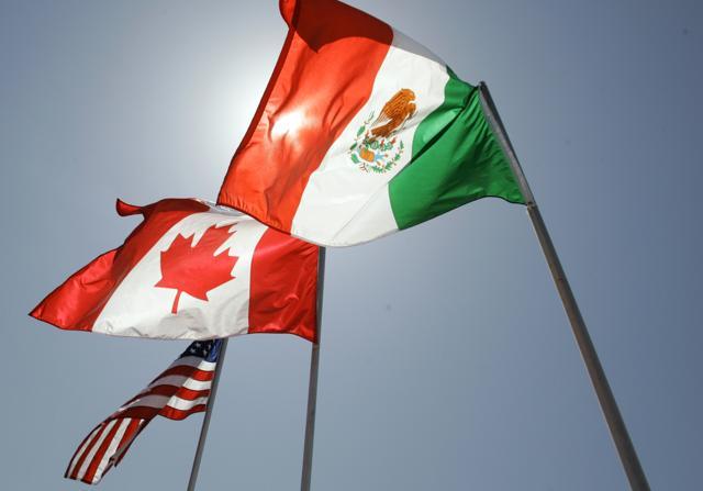 In this April 21, 2008 file photo, national flags representing the United States, Canada, and Mexico fly in the breeze in New Orleans where leaders of the North American Free Trade Agreement met. (AP ) In this April 21, 2008 file photo, national flags representing the United States, Canada, and Mexico fly in the breeze in New Orleans where leaders of the North American Free Trade Agreement met. (AP )