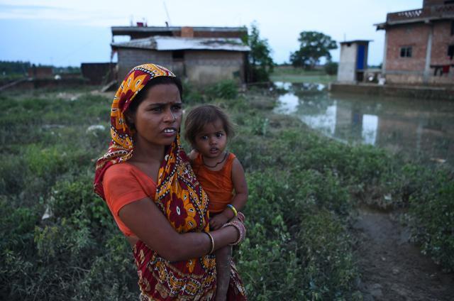 A Nepalese woman carries her child in floodwaters in Janakpur, 300 km southeast of the capital Kathmandu, on August 14, 2017. (AFP) A Nepalese woman carries her child in floodwaters in Janakpur, 300 km southeast of the capital Kathmandu, on August 14, 2017. (AFP)