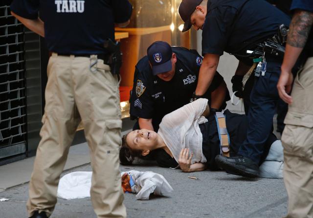 A woman is arrested by police as protesters gather near Trump Tower to protest against US President Donald Trump in New York. (AFP) A woman is arrested by police as protesters gather near Trump Tower to protest against US President Donald Trump in New York. (AFP)