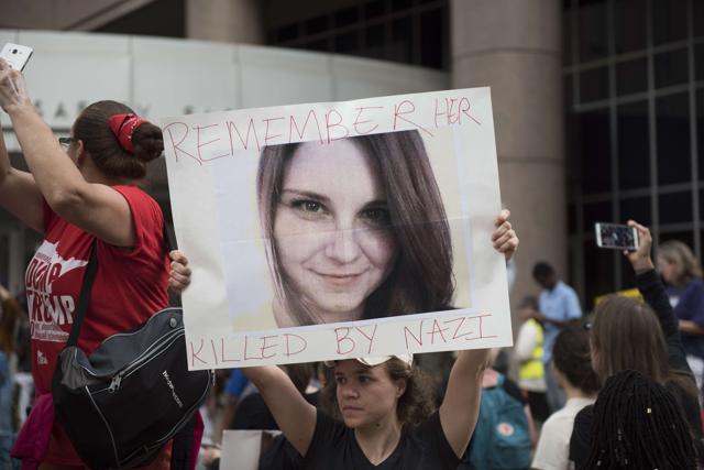 A protesters carries an image of Heather Heyer during a demonstration against racism and the violence over the weekend in Charlottesville, Virginia on August 14, 2017 in Minneapolis, Minnesota. (AFP)