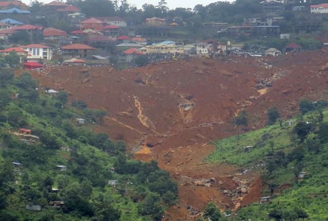 Rescue workers gather at the summit of a mudslide in Regent, east of Freetown, Sierra Leone, Monday, Aug. 14 , 2017. (AP) Rescue workers gather at the summit of a mudslide in Regent, east of Freetown, Sierra Leone, Monday, Aug. 14 , 2017. (AP)