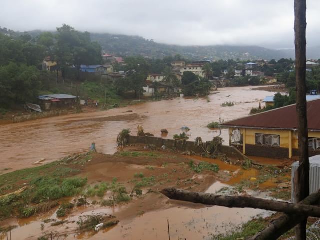 A torrent of water flows through a flooded neighbourhood in Regent, east of Freetown, Sierra Leone, on August 14 , 2017. (AP)