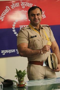 Rajbir holds his gold medal, when at the office of the Commissioner of Police at Civil Lines in Gurgaon. (Manoj Verma/HT Photo)