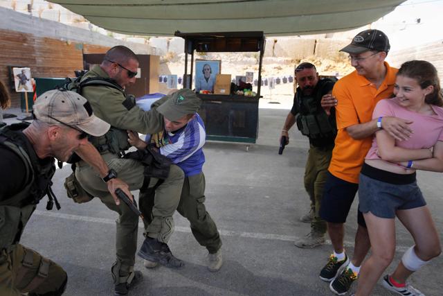 Foreign tourists react as Israeli instructors neutralise a man during a simulation of a knife attack at a market as they participate in a two hour anti-terror course at the Caliber 3 shooting range. (AFP Photo) Foreign tourists react as Israeli instructors neutralise a man during a simulation of a knife attack at a market as they participate in a two hour anti-terror course at the Caliber 3 shooting range. (AFP Photo)