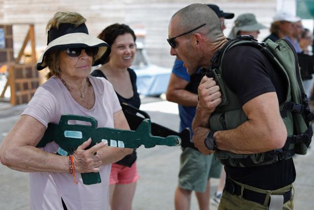 Foreign tourists train with a wooden gun as they participate in a two hour anti-terror course at the Caliber 3 shooting range. (AFP Photo) Foreign tourists train with a wooden gun as they participate in a two hour anti-terror course at the Caliber 3 shooting range. (AFP Photo)