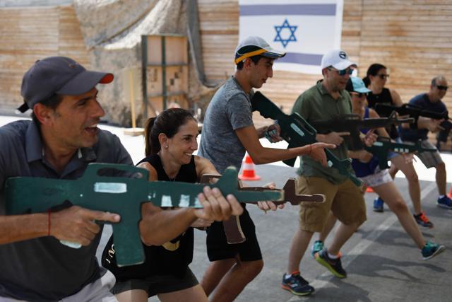 Foreign tourists train with a wooden gun as they participate in a two hour anti-terror course at the Caliber 3 shooting range, near the West Bank settlement of Efrat. (AFP Photo) Foreign tourists train with a wooden gun as they participate in a two hour anti-terror course at the Caliber 3 shooting range, near the West Bank settlement of Efrat. (AFP Photo)