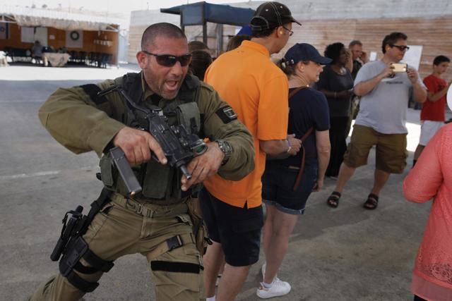 Foreign tourists watch instructors shoot as they participate in a two hour anti-terror course at the Caliber 3 shooting range. (AFP Photo) Foreign tourists watch instructors shoot as they participate in a two hour anti-terror course at the Caliber 3 shooting range. (AFP Photo)