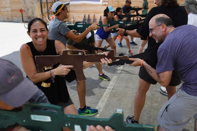 Foreign tourists train with a wooden gun as they participate in a two hour anti-terror course at the Caliber 3 shooting range. (AFP Photo) Foreign tourists train with a wooden gun as they participate in a two hour anti-terror course at the Caliber 3 shooting range. (AFP Photo)