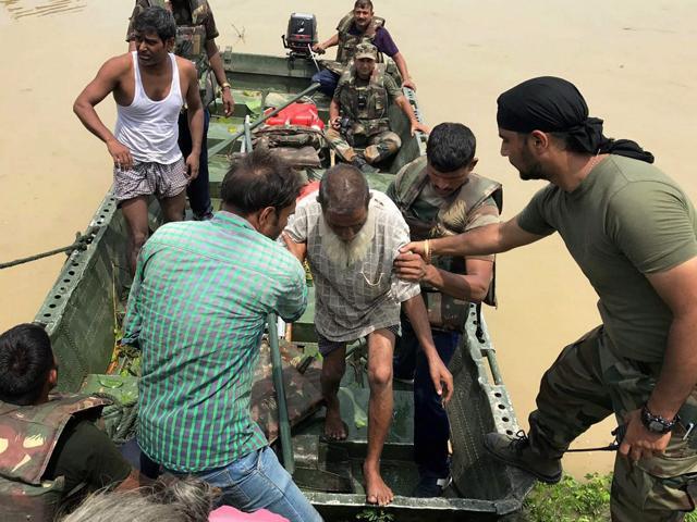 Army personnel rescue flood victims from villages in Katihar district, Bihar on Wednesday. Heavy rains have triggered flash floods in Bihar. (PTI Photo) Army personnel rescue flood victims from villages in Katihar district, Bihar on Wednesday. Heavy rains have triggered flash floods in Bihar. (PTI Photo)