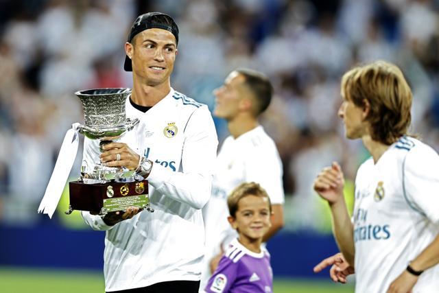 Real Madrid's Cristiano Ronaldo holds the trophy while celebrating with teammates after winning the Spanish Super Cup against Barcelona at the Santiago Bernabeu Stadium in Madrid, Thursday. Real Madrid won 5-1 on aggregate. (AP) Real Madrid's Cristiano Ronaldo holds the trophy while celebrating with teammates after winning the Spanish Super Cup against Barcelona at the Santiago Bernabeu Stadium in Madrid, Thursday. Real Madrid won 5-1 on aggregate. (AP)