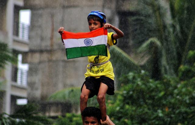 A kid with Tricolor flag during Dahi Handi in Thane, India, on Tuesday. (Praful Gangurde) A kid with Tricolor flag during Dahi Handi in Thane, India, on Tuesday. (Praful Gangurde)
