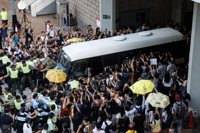 Police and supporters of Hong Kong's pro-democracy Umbrella Movement surround a prison van transporting student activist Joshua Wong after his sentencing at the Hong Kong high court on August 17. (AFP) Police and supporters of Hong Kong's pro-democracy Umbrella Movement surround a prison van transporting student activist Joshua Wong after his sentencing at the Hong Kong high court on August 17. (AFP)