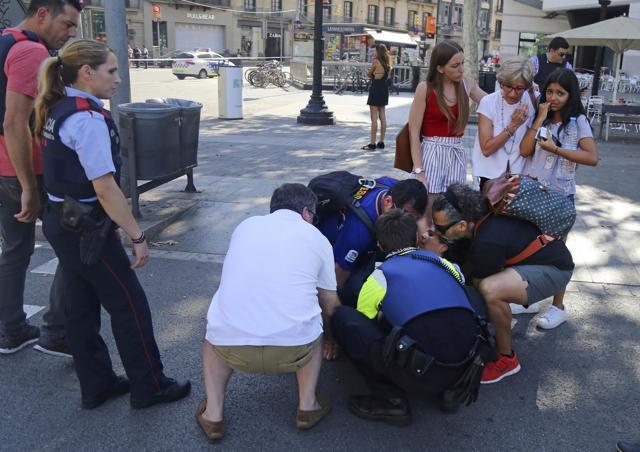 A person is treated in Barcelona, Spain, Thursday, Aug. 17, 2017 after a white van jumped the sidewalk in the historic Las Ramblas district, crashing into a summer crowd of residents and tourists and injuring several people, police said. (AP) A person is treated in Barcelona, Spain, Thursday, Aug. 17, 2017 after a white van jumped the sidewalk in the historic Las Ramblas district, crashing into a summer crowd of residents and tourists and injuring several people, police said. (AP)