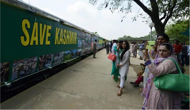 People look on as the Azadi Train prepares to start its journey from Margalla railway station in Islamabad at the time of its inaugural run in August 2016. (AFP)