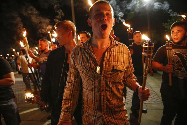 Multiple white nationalist groups march with torches through the UVA campus in Charlottesville. (AP Photo) Multiple white nationalist groups march with torches through the UVA campus in Charlottesville. (AP Photo)